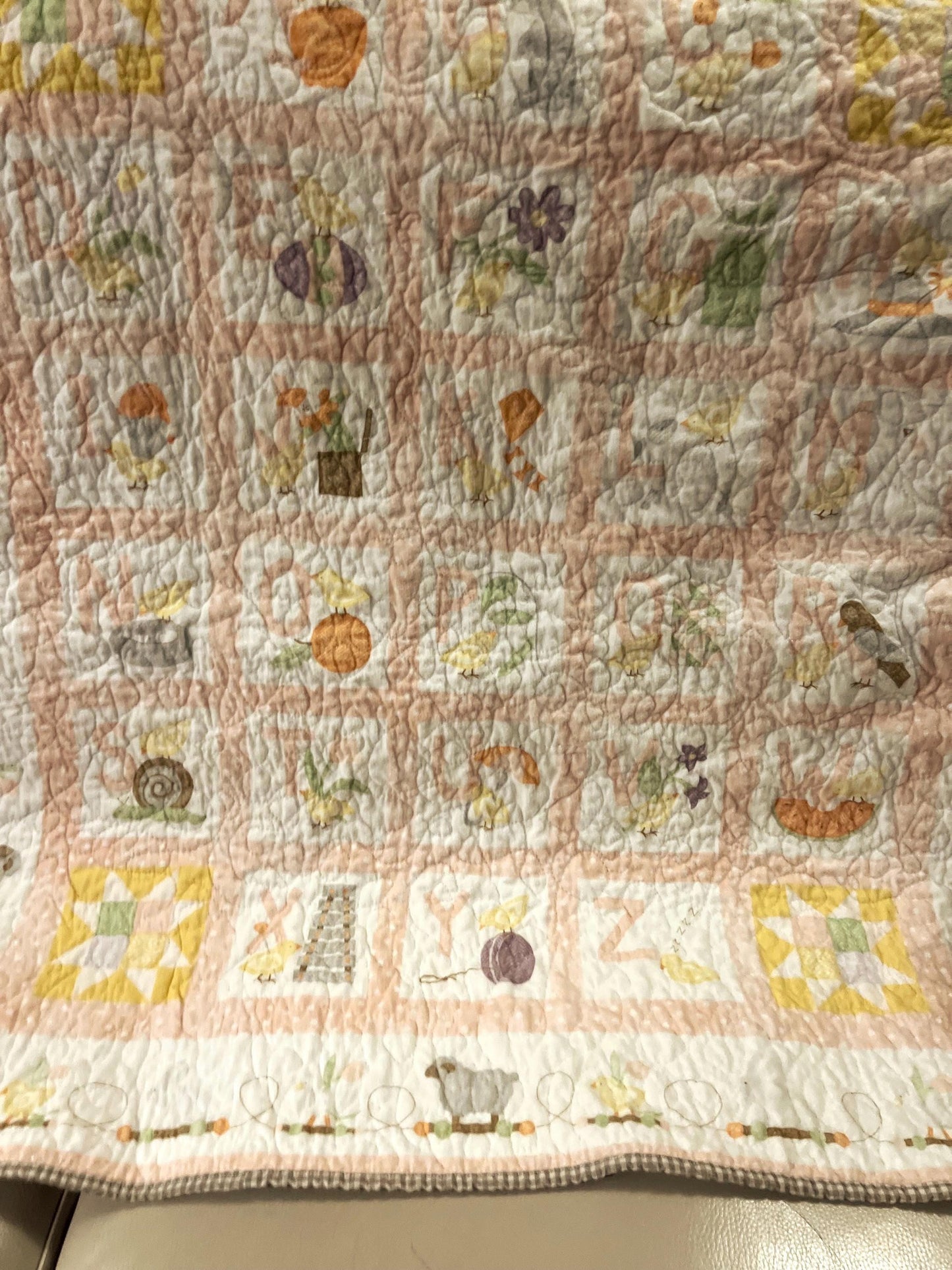 Handmade quilted baby blanket with alphabets, animals, light pastel colors