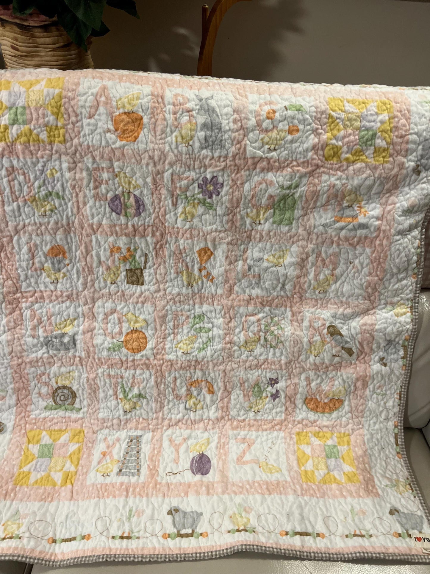 Handmade quilted baby blanket with alphabets, animals, light pastel colors