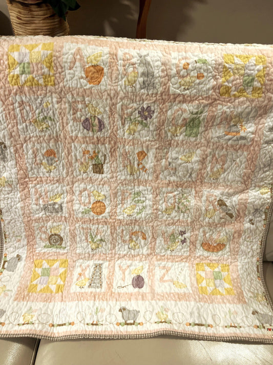 Handmade quilted baby blanket with alphabets, animals, light pastel colors